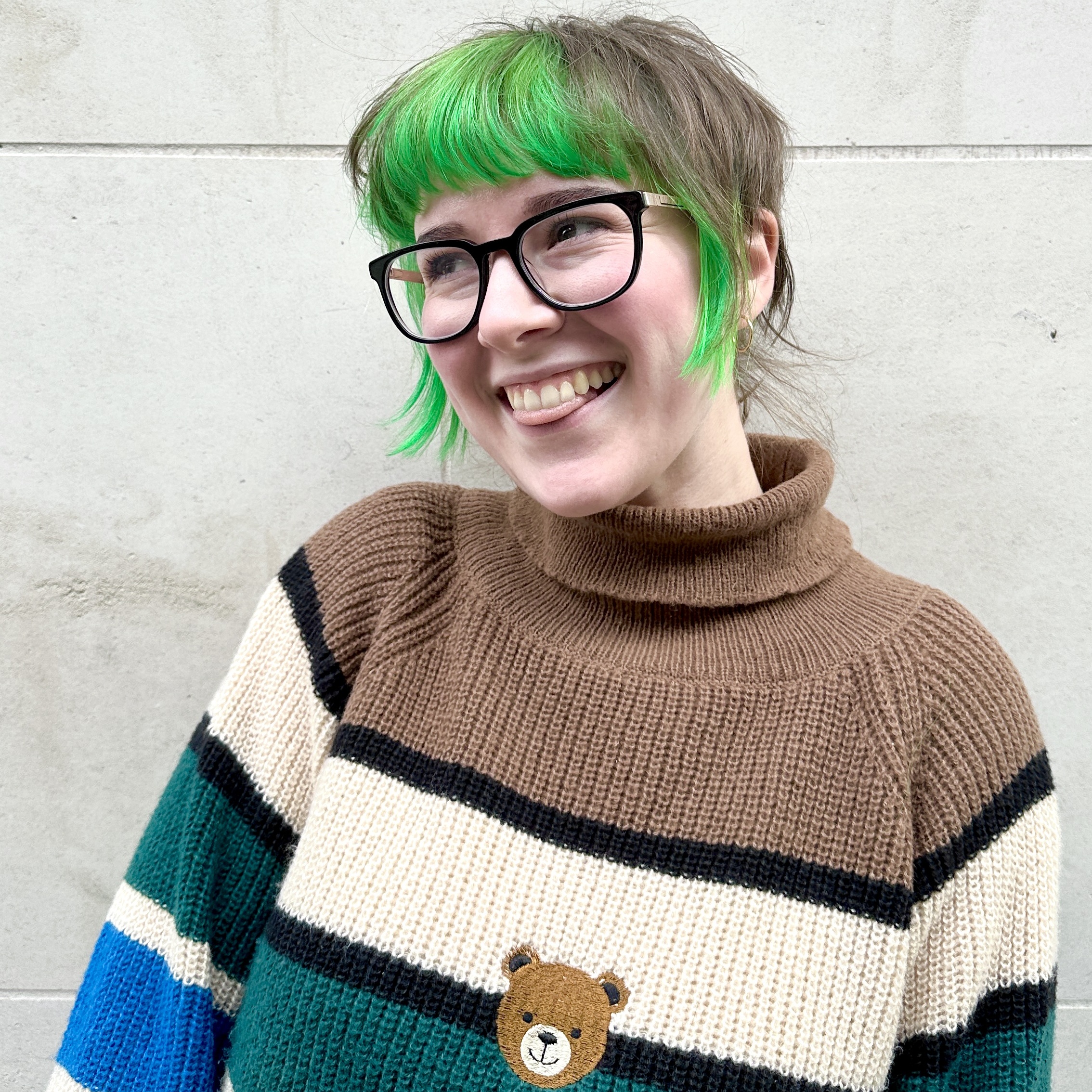 Beth smiling in a striped jumper